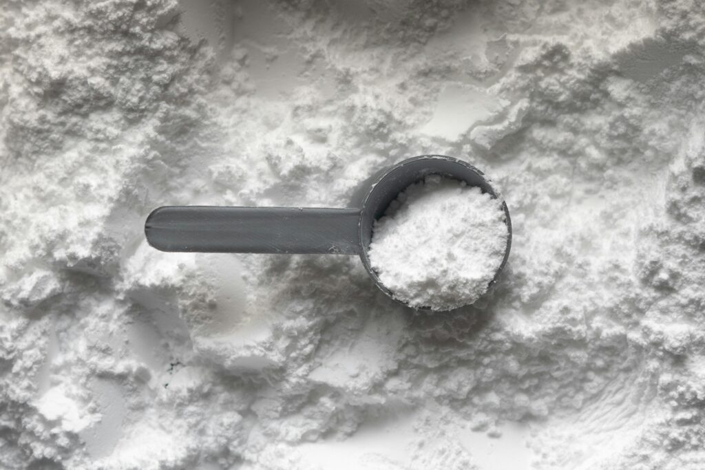 a pile of creatine with a scoop
